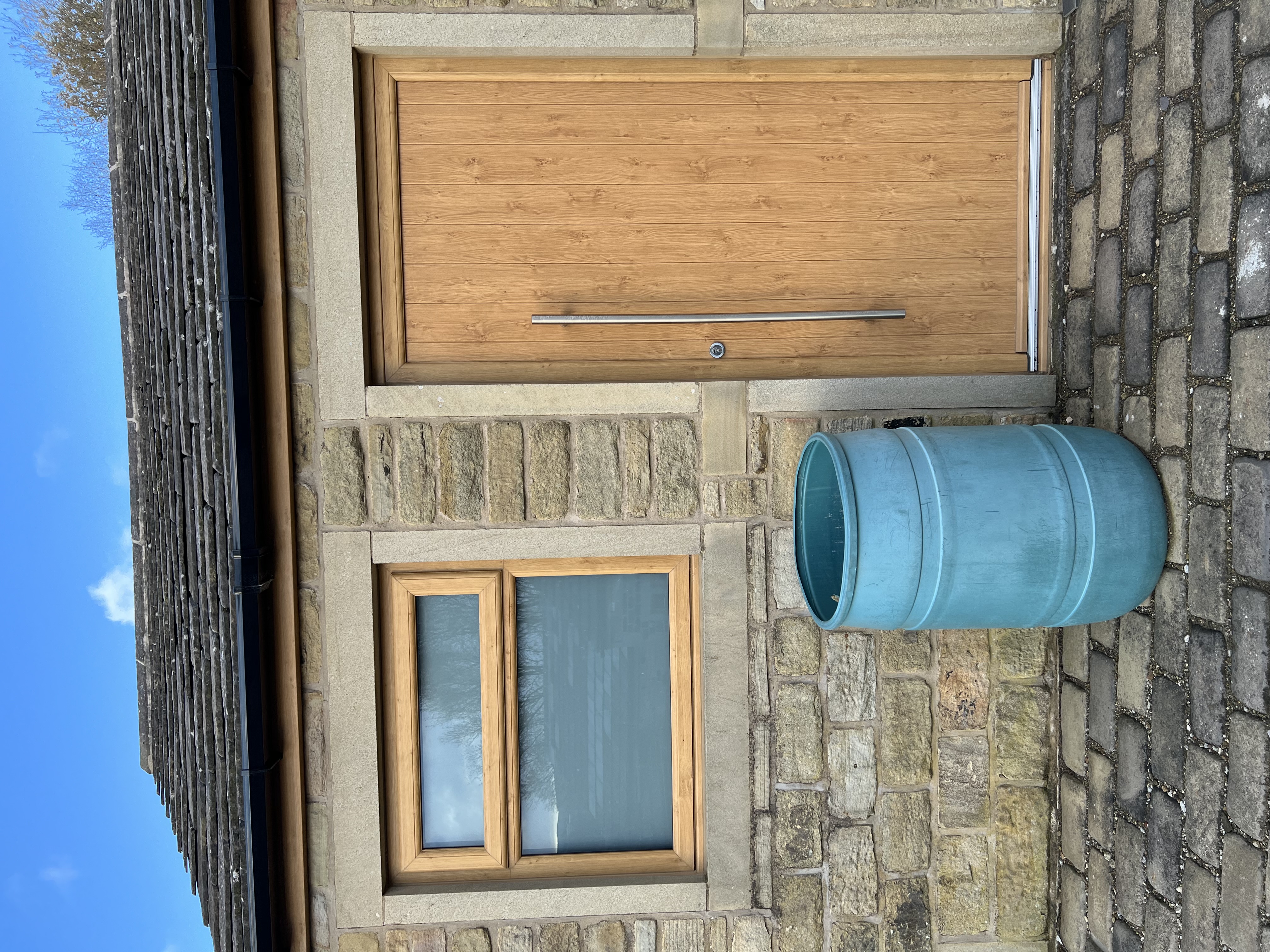 Flint solid composite door in Irish Oak with 1200mm door handle
