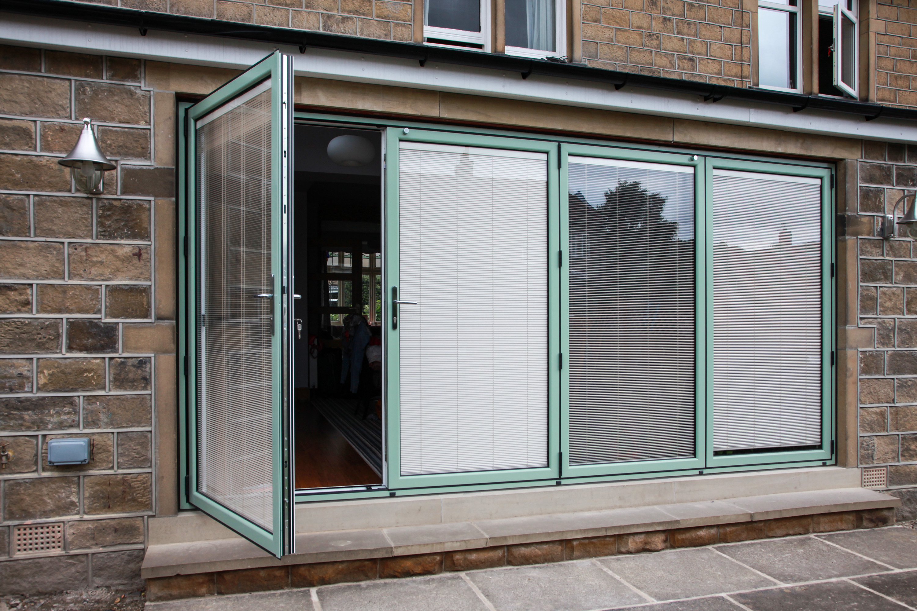 Aluminium bi-fold doors in Chartwell Green