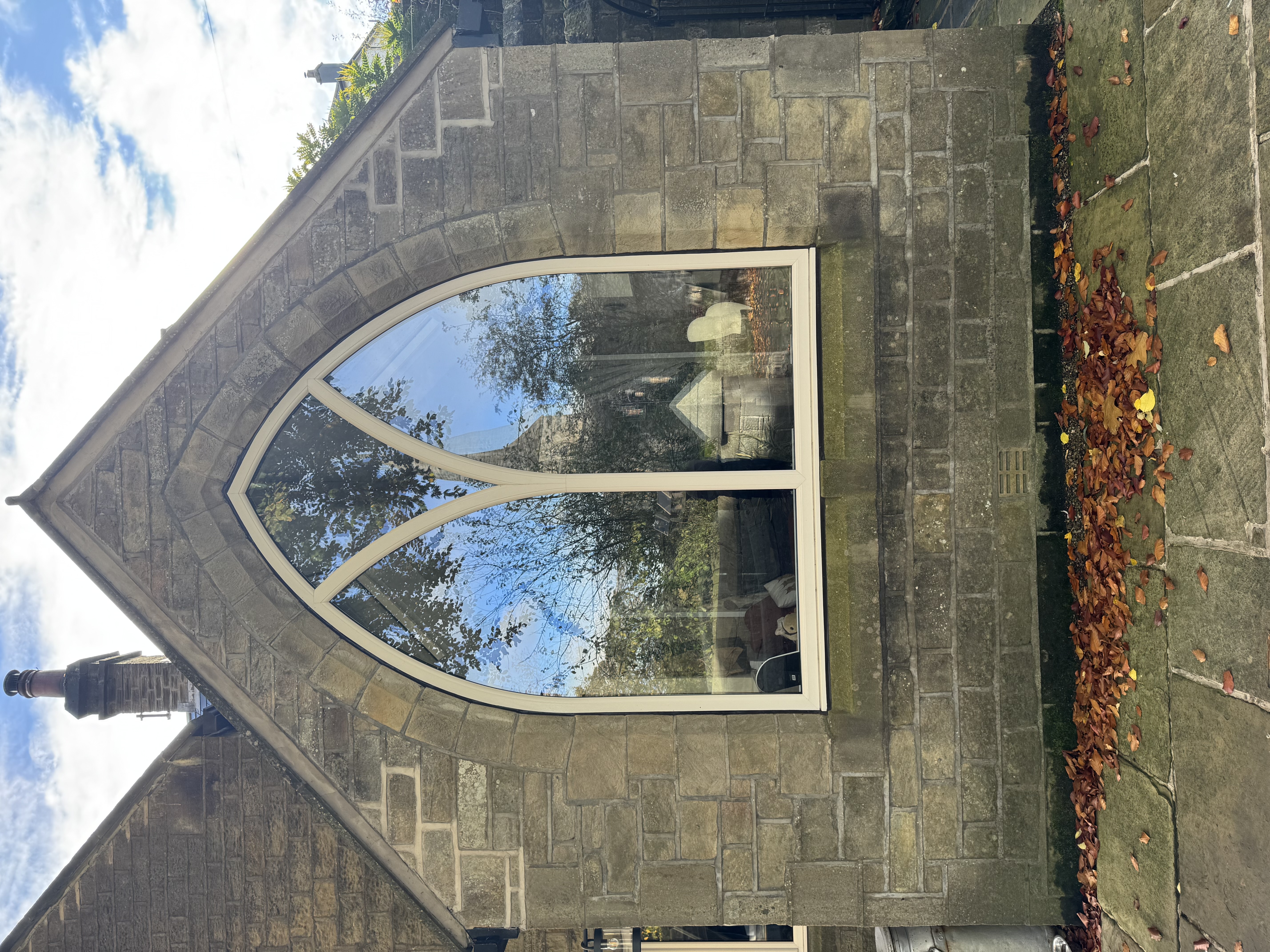 Cream uPVC shaped window in old chapel