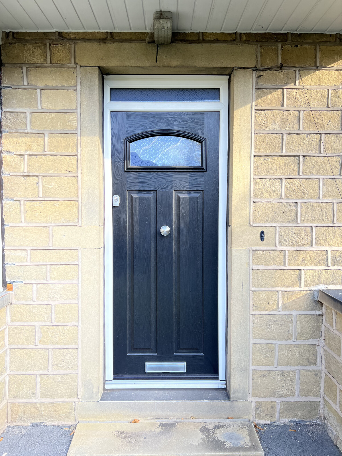 Black London composite door with Heritage handle and Canterbury glass