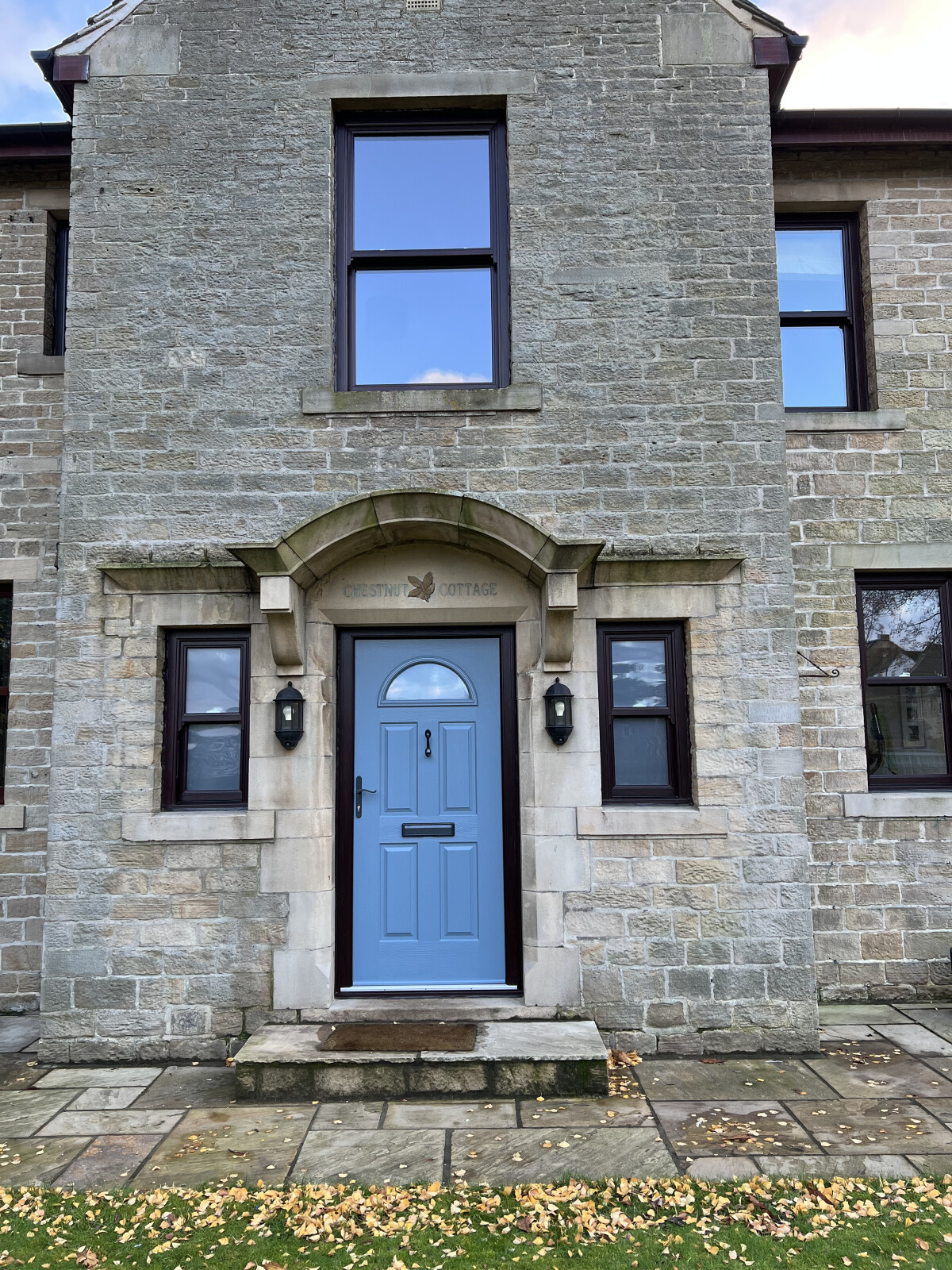 Conway 1 composite door in Twilight Grey with Rosewood frame and Rosewood sliding sash windows and satin glass