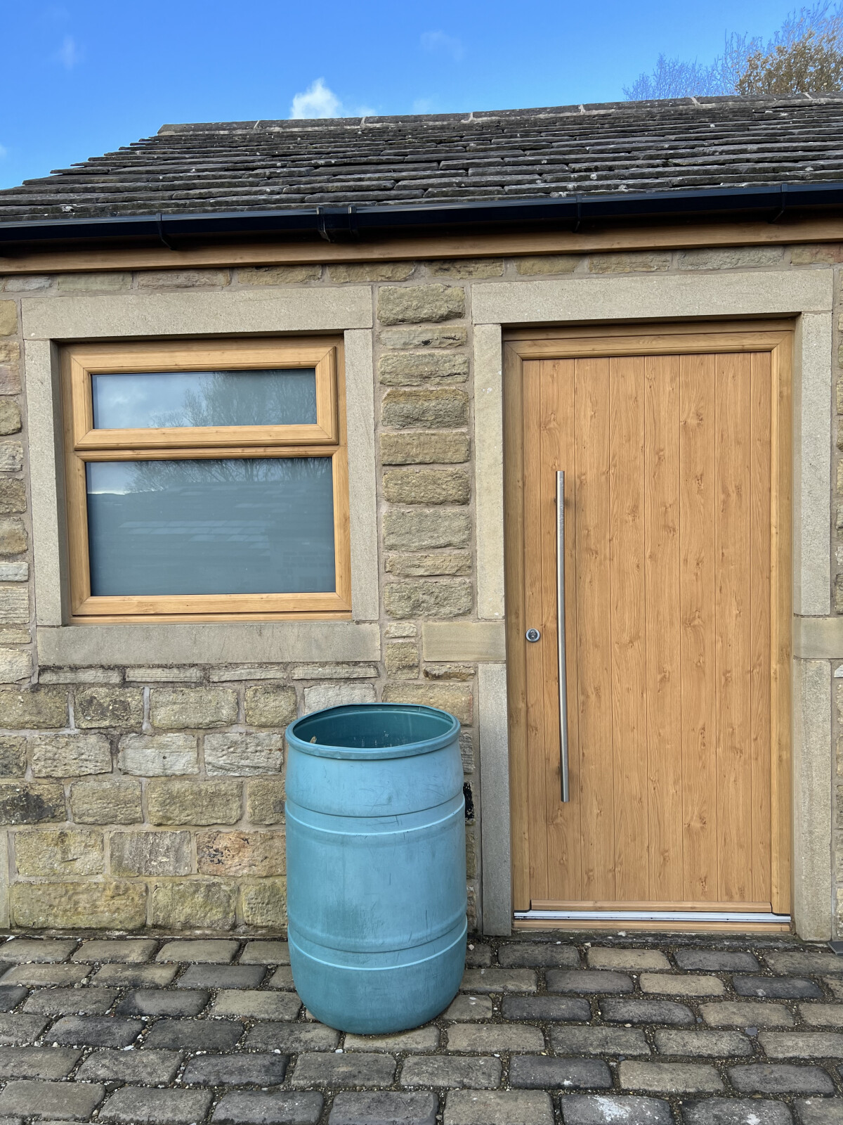 Flint solid composite door in Irish Oak with 1200mm door handle