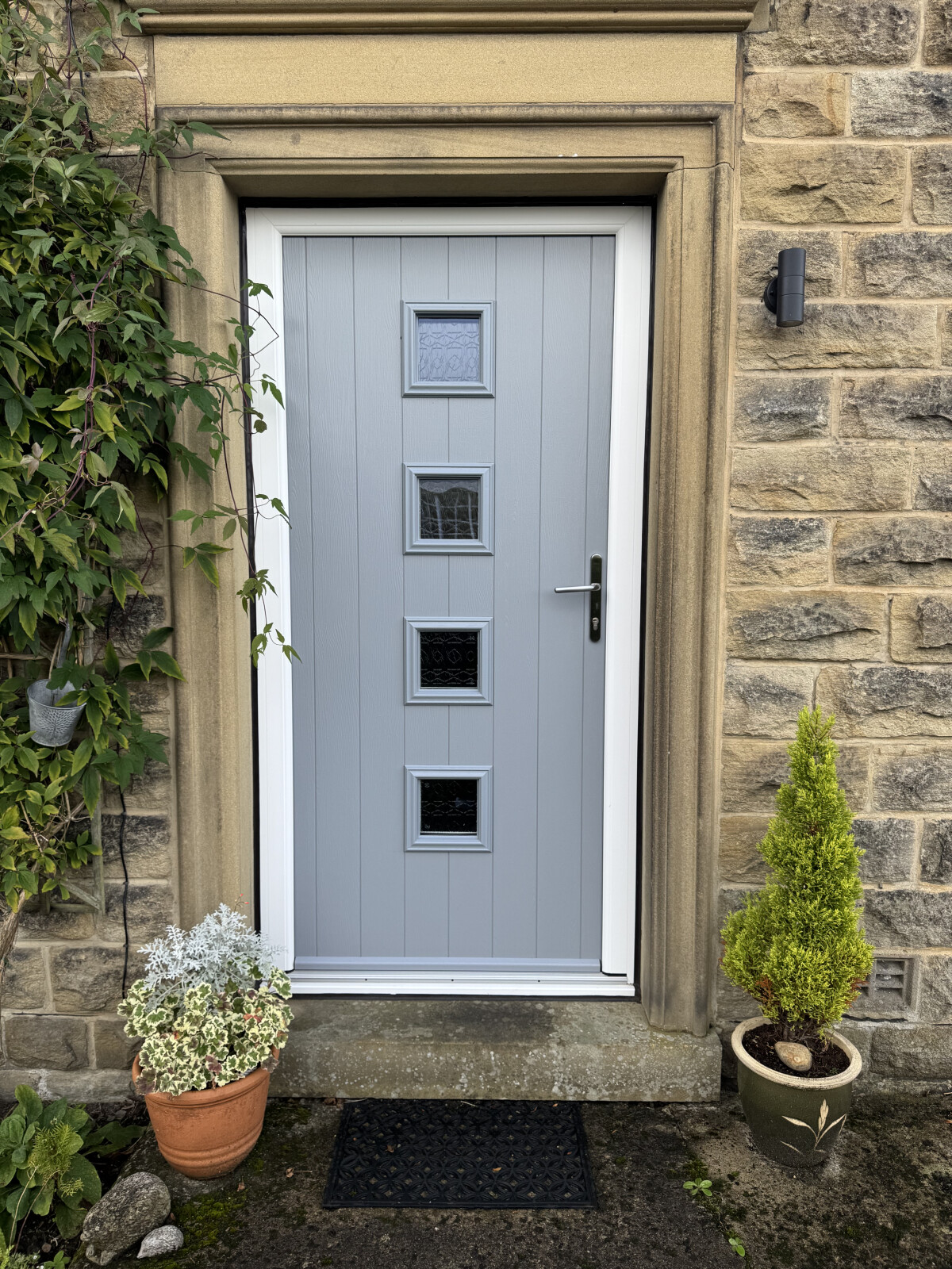 French Grey Parma composite door in white uPVC frame, Tribal glass and Chrome handle