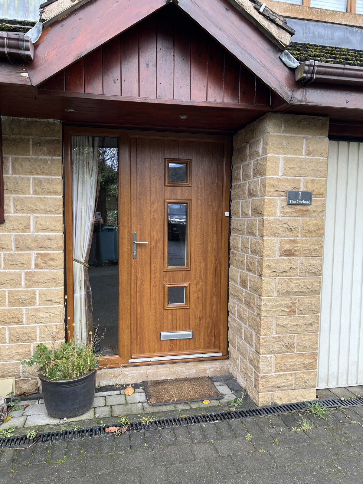 Genoa composite door in Oak with Stipple glass