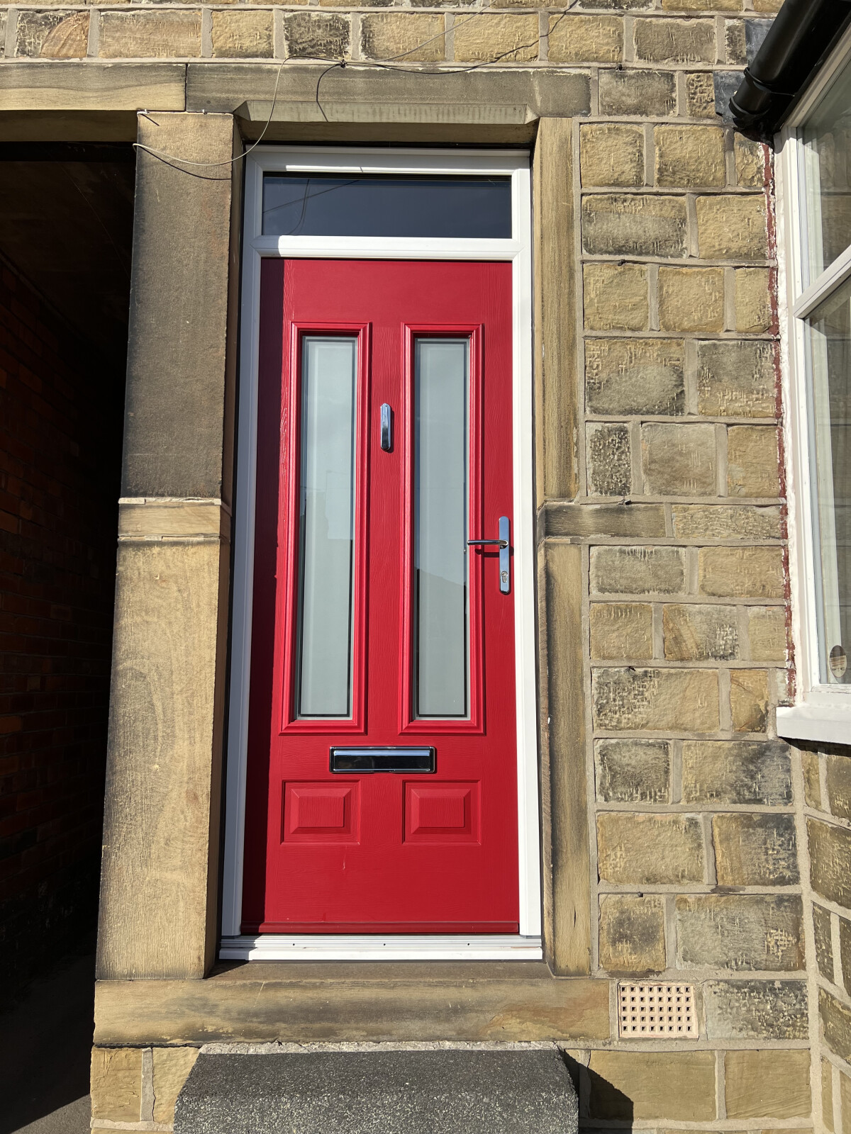 Edinburgh composite door in Ruby Red with Victorian border glass
