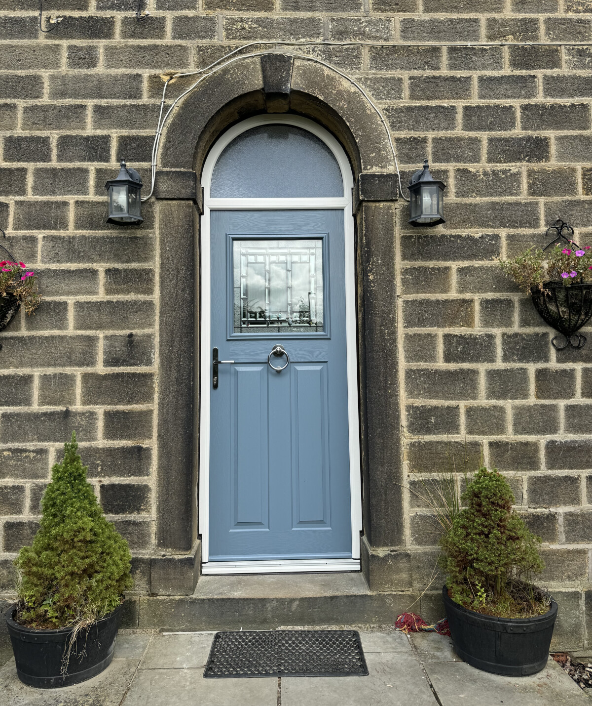 Twilight Grey on Irish Oak Stirling composite arched door in White frame with Contora top light, New Orleans glass, graphite handle and ring knocker