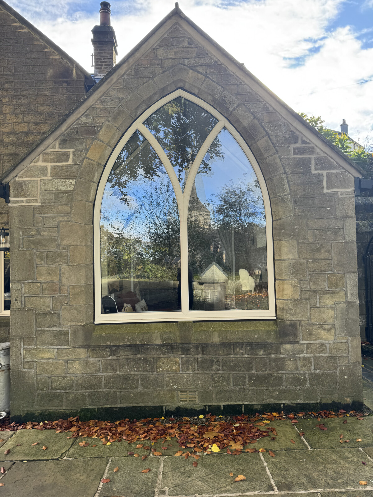 Cream uPVC shaped window in old chapel
