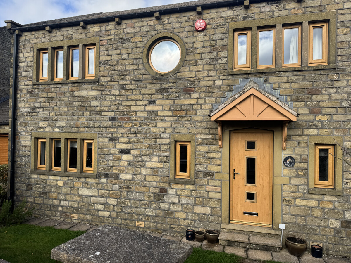Irish Oak uPVC windows including one porthole window, with clear glass and trickle vents